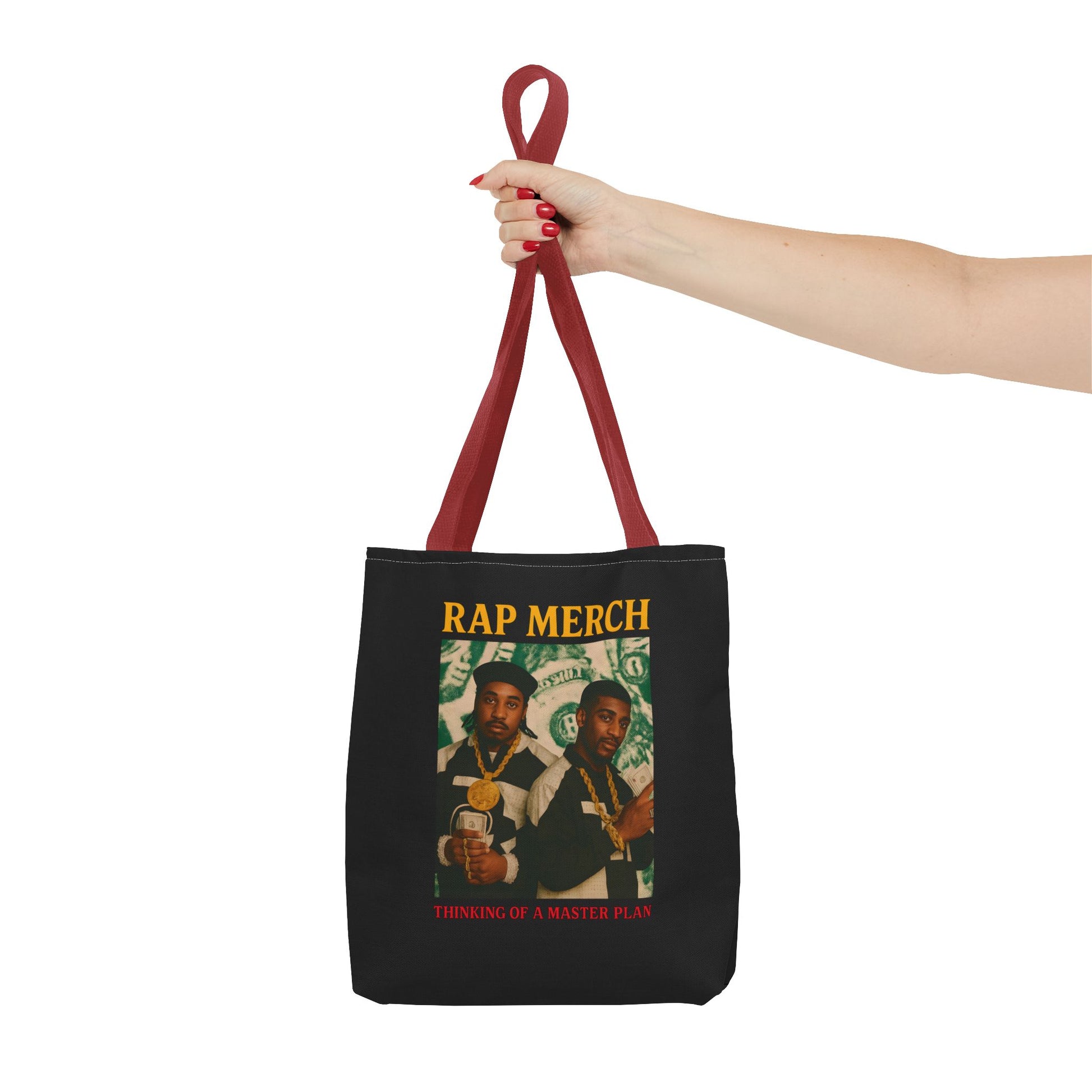 Black tote bag with 'Rap Merch' design held by a hand on a white background