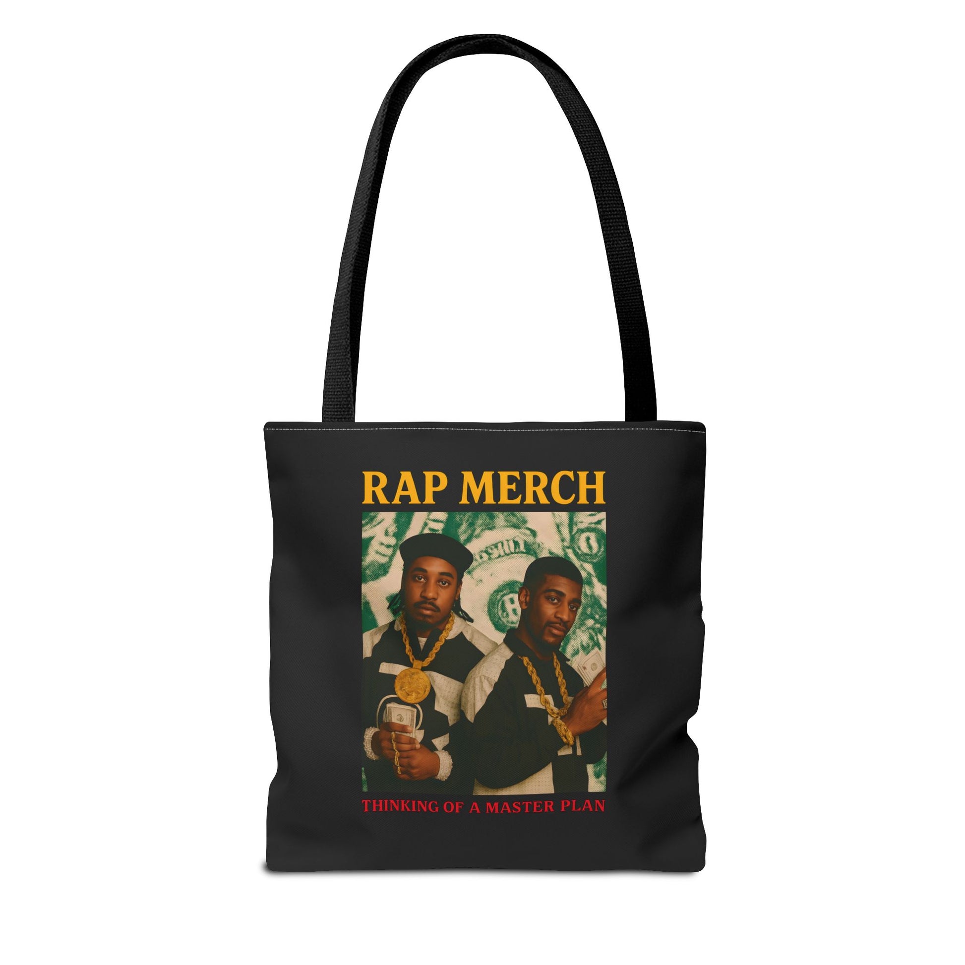 Black tote bag with 'Rap Merch' design featuring two individuals and money graphics on a white background.