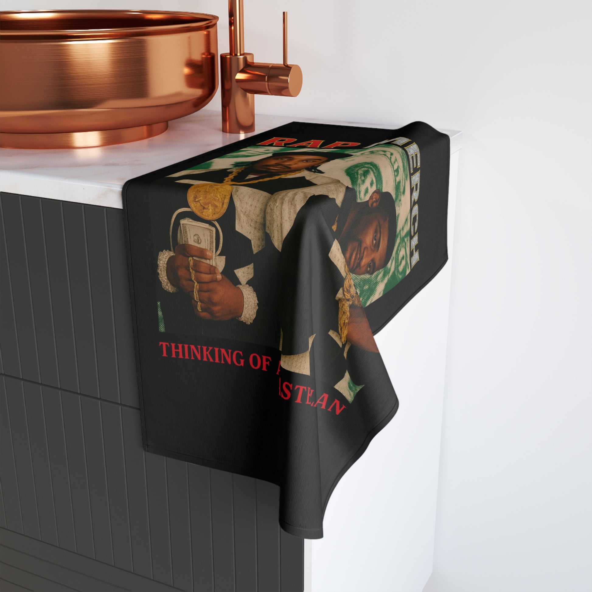 Towel with graphic design draped over a sink in a kitchen setting