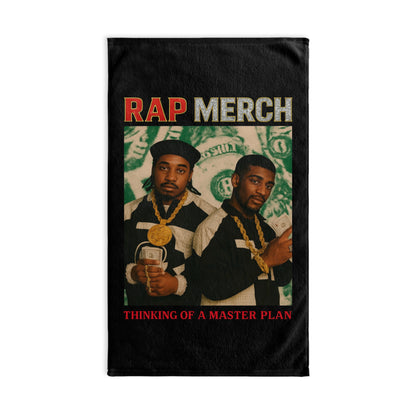 T-shirt with two individuals holding money and text 'Rap Merch' and 'Thinking of a Master Plan' on a black background.