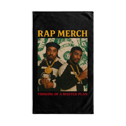Black t-shirt with graphic of two men, gold chains, and text 'RAP MERCH Thinking of a Master Plan' on a white background.