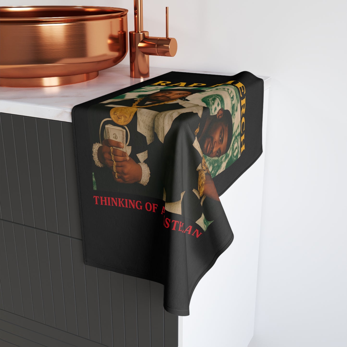 Towel with a graphic design hanging over a sink in a bathroom setting